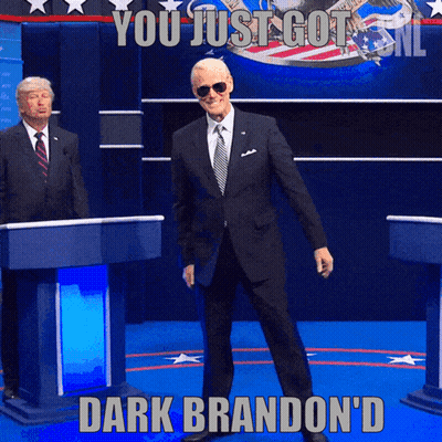 Man In Suit At Podium Saying You Just Got Dark Brandon'd GIF