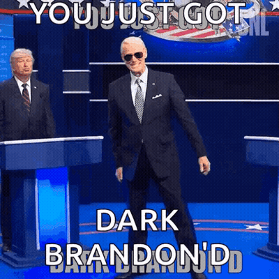 Man In Suit At Podium Saying You Just Got Dark Brandon GIF