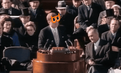 Man In Suit At Podium With Cat On Face GIF