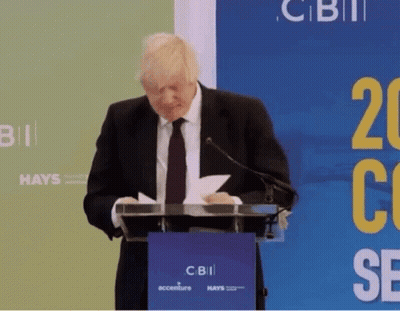 Man In Suit At Podium With CBII Sign GIF