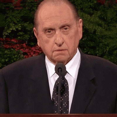 Man In Suit At Podium With Microphone GIF
