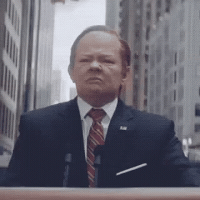 Man In Suit At Podium GIF