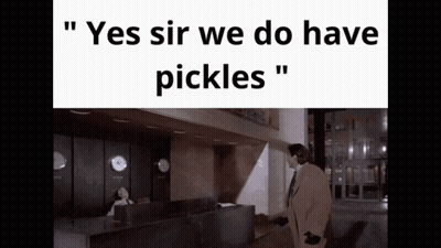 Man In Suit At Reception Desk Saying Yes Sir We Do Have Pickles GIF