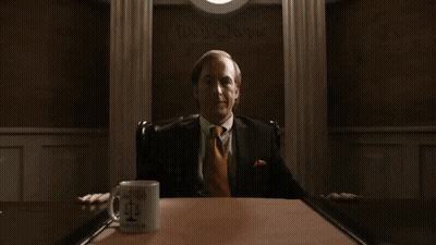 Man In Suit At Table With Justice Mug GIF