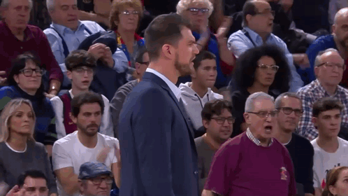 Man In Suit Before Crowd With Polo Shirt Man GIF