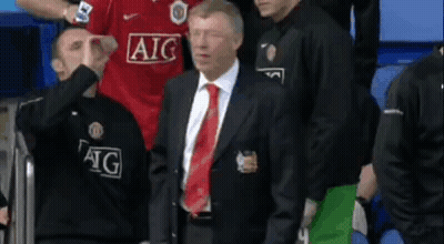 Man In Suit Before Group In AIG Jerseys GIF