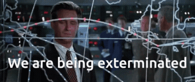 Man In Suit Before Screen Saying We Are Being Exterminated GIF