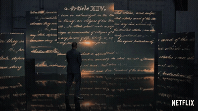 Man In Suit Before Wall Of Handwritten Article XIV GIF
