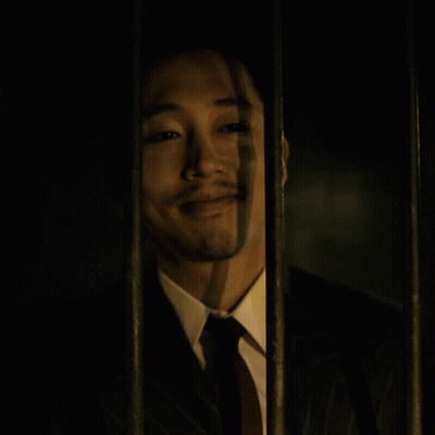 Man in Suit Behind Bars Eyes Closed