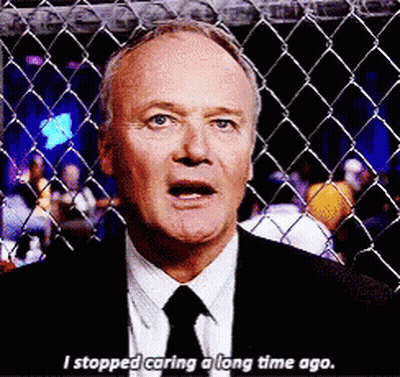 Man In Suit Behind Fence Saying I Stopped Caring GIF