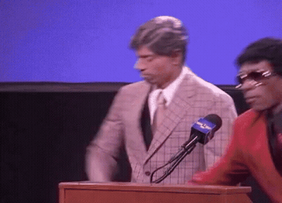 Man In Suit Behind Podium With Fox News Microphone GIF