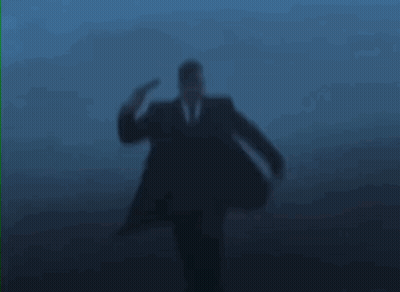 Hombre de traje recibiendo un disparo en la cabeza GIF