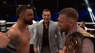 Man In Suit Between Boxers Lions Boy Sign GIF