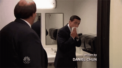 Man In Suit Blowing Nose In Mirror Daniel Chun GIF