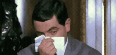 Man In Suit Blowing Nose With Napkin GIF