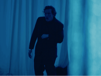 Man In Suit By Blue Wall GIF