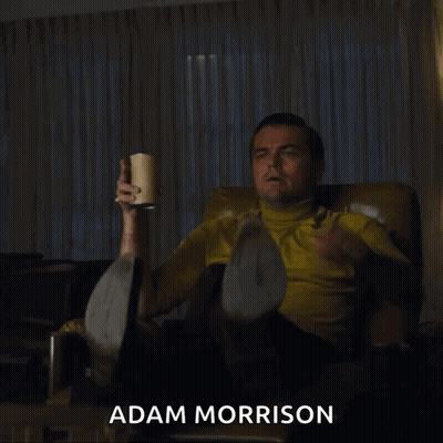 Man In Suit By Sign That's A GIF