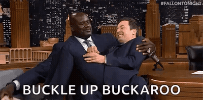 Man In Suit Carrying Another Man Buckle Up Buckaroo GIF