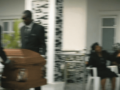 Man In Suit Carrying Coffin Blurry Photo GIF