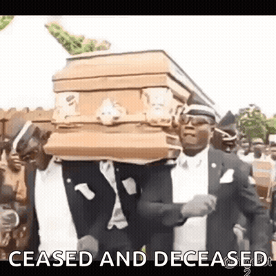 Man In Suit Carrying Coffin In Cemetery GIF