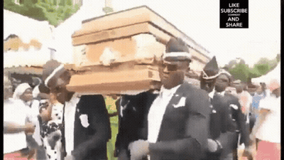 Man In Suit Carrying Coffin On Head GIF