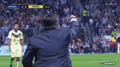 Man In Suit Celebrating On Soccer Field GIF