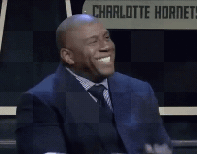 Man In Suit Clapping Before Charlotte Hornets Sign GIF