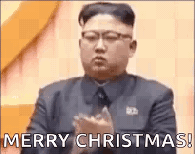 Man In Suit Clapping Saying Merry Christmas GIF