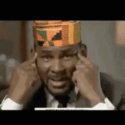 Man In Suit Covering Ears With Hat GIF