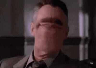 Man In Suit Covering Face GIF