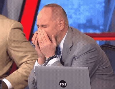 Man In Suit Covering Face In Front Of TNT Laptop GIF