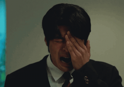 Man In Suit Covering Face With Hand GIF