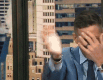 Man In Suit Covering Face With Hands GIF