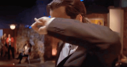 Man In Suit Covering Face With Jacket GIF