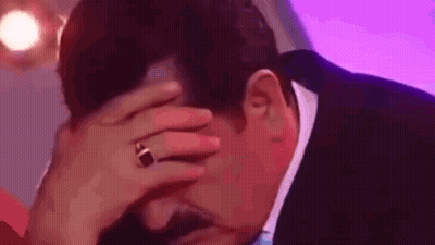 Man In Suit Covering Face With Wedding Ring GIF