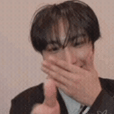 Man In Suit Covering Mouth And Thumbs Up GIF