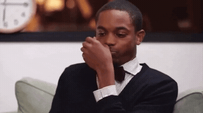 Man In Suit Covering Nose GIF