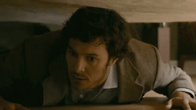 Man In Suit Crawling Under Table GIF