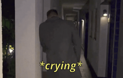 Man In Suit Crying In Hallway At Night GIF