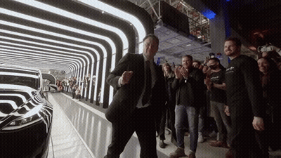 Man in Suit Dancing Before Crowd