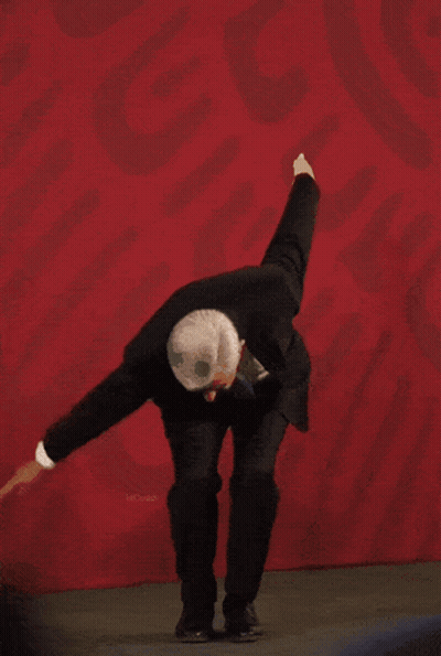 Man In Suit Dancing Before Red Wall With Mexico GIF