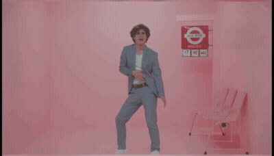 Man In Suit Dancing By Pink Wall I Need Your Love GIF