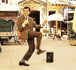 Man In Suit Dancing By Speaker On Street GIF