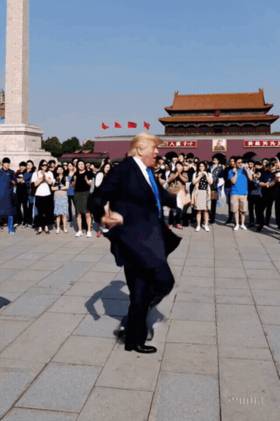 Man In Suit Dancing In Front Of Chinese Building GIF