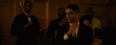 Man in Suit Dancing in Front of Crowd