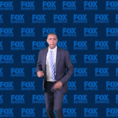 Man In Suit Dancing In Front Of Fox Deportes Wall GIF