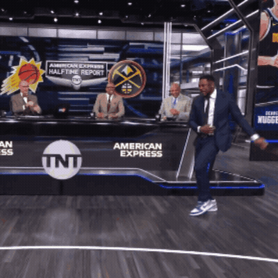 Man In Suit Dancing In Front Of TNT American Express Sign GIF