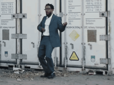 Man In Suit Dancing In Front Of UIC Railway Container GIF