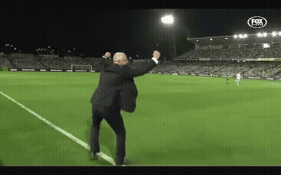 Man In Suit Dancing On Soccer Field With Fox Logo GIF