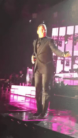 Man In Suit Dancing On Stage GIF